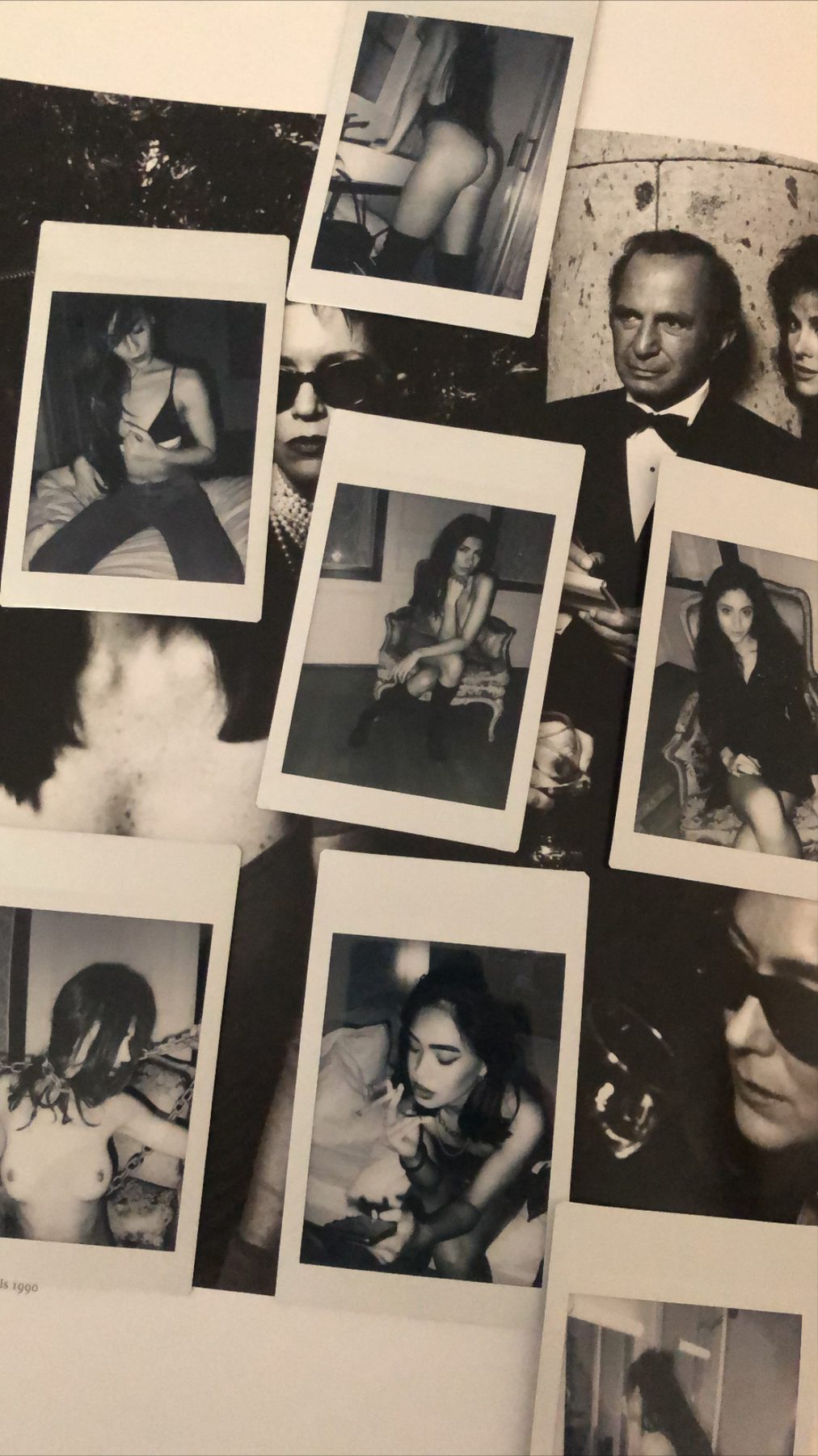 Instant prints from a boudoir session laid out on a table